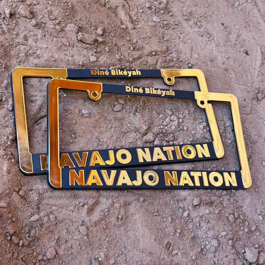 2 frames - "We are Navajo Nation" Car License Plate Frame (Gold-Black text)